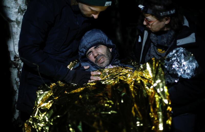 Kader, 39, a Syrian migrant from Homs, looks exhausted as he is rescued by NGO workers during the migrant crisis at the Belarus border, near Topczykaly, Poland. Reuters
