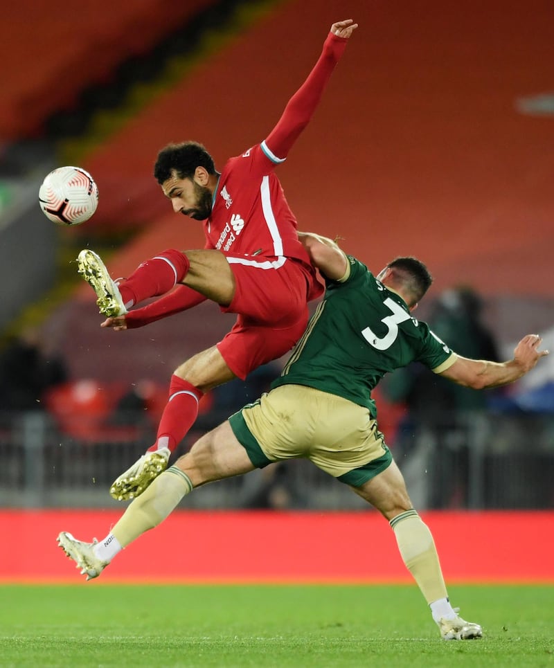 Liverpool's Mohamed Salah is challenged by Enda Stevens of Sheffield United. Reuters