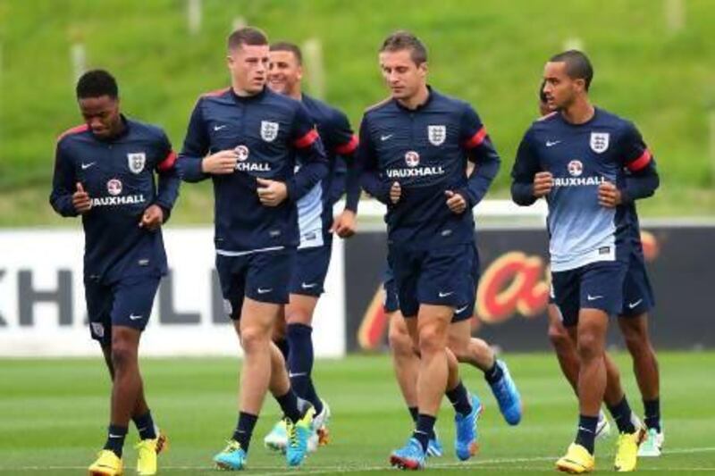 Ross Barkley, Phil Jagielka and Theo Walcott of England warm up during a training session at St Georges Park in Burton-upon-Trent.