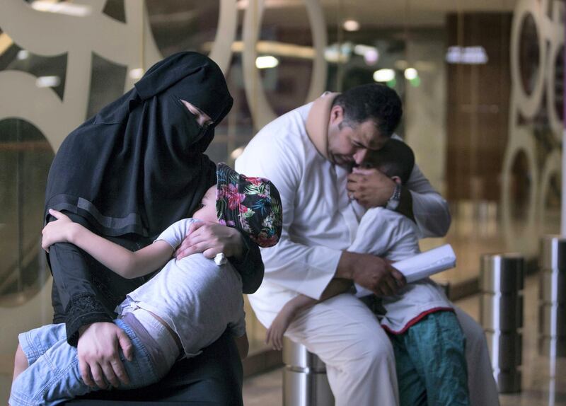 DUBAI, UNITED ARAB EMIRATES, MARCH 30, 2018 - 
Alruwayda, with her son Abdul Hadi and her husband Mahmoud Nimr in the background with her other son Rahed. The family is asking for donations to help pay for rent and expenses in Deira, Dubai. (Leslie Pableo for The National)

