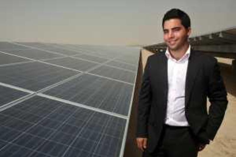June 21, 2009 / Abu Dhabi / Ayham Mkalalati a solar panel engineer stands next to Masdar's 10 mega watt solar voltaic panels June 21, 2009. (Sammy Dallal / The National)



 *** Local Caption ***  sd-062109-solar-06.jpg