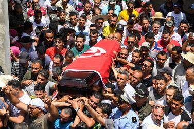Mourners carry the coffin of killed Tunisian police officer Sgt. Arbi Guizani during a funerary procession in capital Tunis' northwestern suburb of Ettadhamen on July 9, 2018. AFP 