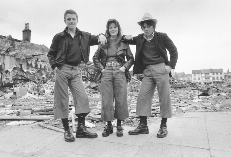 4th June 1974:  Teenagers wearing the latest trend, cropped trousers known as 'parallels', in the ruins of Smithfield Market in Belfast, Northern Ireland. (Photo by Frank Tewkesbury/Evening Standard/Hulton Archive/Getty Images)