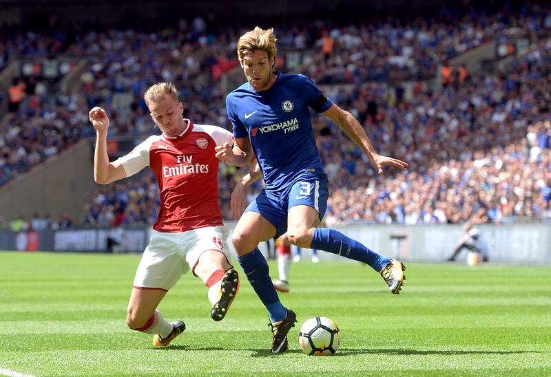 Chelsea's Marcos Alonso and Arsenal's Rob Holding battle for the ball. Joe Giddens /PA