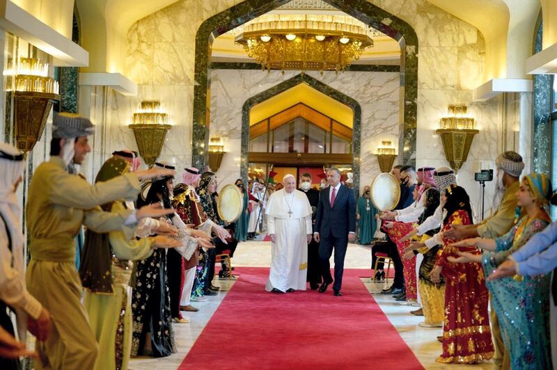 The Pope is welcomed by Iraq's prime minister Mustafa Al Kadhimi on arrival at Baghdad airport. Handout from the office of the Prime Minister of Iraq