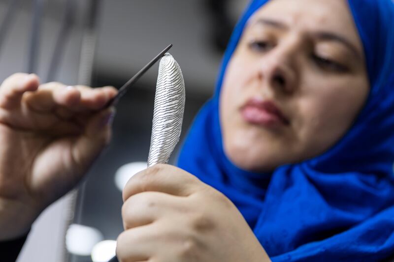 ABU DHABI, UNITED ARAB EMIRATES - December 12, 2016: Emirati jeweler and designer Azza Al Qubaisi works in her studio in downtown Abu Dhabi. Educated in London, she studied at Chelsea College of Art and Design (Diploma of Foundation Studies), continued to obtain her B.A in London Guildhall University (Silversmithing, Jewellery Design and Allied Crafts) and is a certified HRD diamond grade. After her graduation Al Qubaisi paved the way as the First Jewellery Artist, Corporate Gift and Awards Designer in the UAE. She founded two governmental projects to support and develop handcrafts and established the first platform to showcase local crafts and design in Abu Dhabi “Made in UAE”. Al Qubaisi's contemporary style and singular vision saw her named the British Council's most successful UAE Young Design Entrepreneur in Fashion and Design as well as several other awards. She worked with cuttlefish for one collection, using an ancient technique to fashion it into pendants and rings.

( Photo / Silvia Razgova)