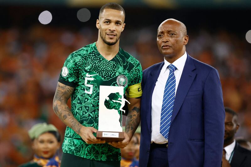 Nigeria defender William Troost-Ekong holds the Golden Ball award while standing next to President of the Confederation of African Football (CAF) Patrice Motsepe during prize giving ceremony. AFP