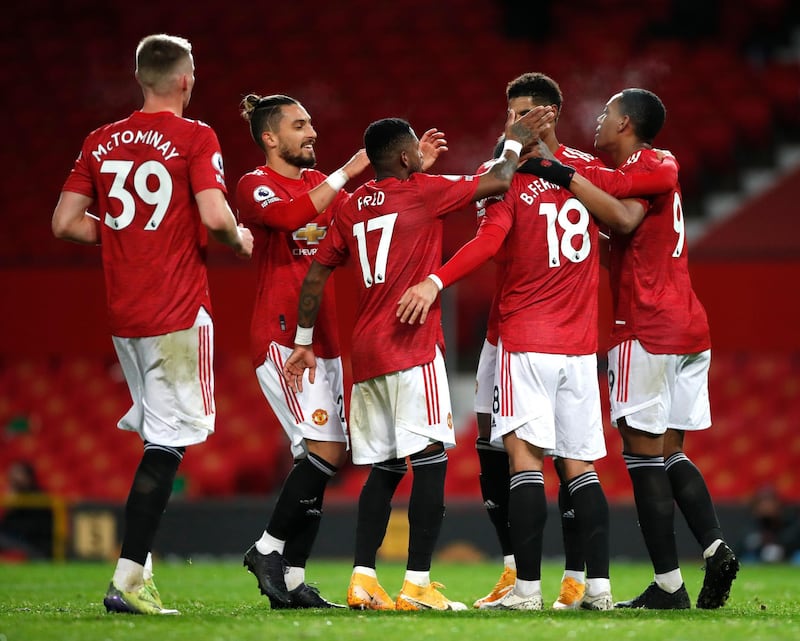 MANCHESTER, ENGLAND - DECEMBER 20: Bruno Fernandes of Manchester United celebrates with team mates (l - r) Scott McTominay, Alex Telles, Fred, Marcus Rashford and Anthony Martial after scoring their sides sixth goal during the Premier League match between Manchester United and Leeds United at Old Trafford on December 20, 2020 in Manchester, England. The match will be played without fans, behind closed doors as a Covid-19 precaution. (Photo by Clive Brunskill/Getty Images)