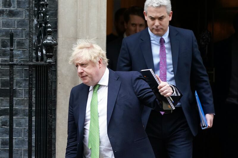 Prime Minister Boris Johnson followed by Downing Street Chief of Staff Steve Barclay, right, outside Downing Street in London.  AP