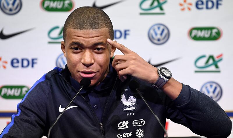 France's forward Kylian Mbappe gestures as he speaks during a press conference in Clairefontaine en Yvelines on October 5, 2017, as part of the team's preparation for the FIFA World Cup 2018 qualifying football match against Bulgaria and Belarus. / AFP PHOTO / FRANCK FIFE