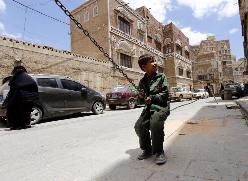 A Yemeni child plays at a street in the old quarter of Sanaa, Yemen. EPA