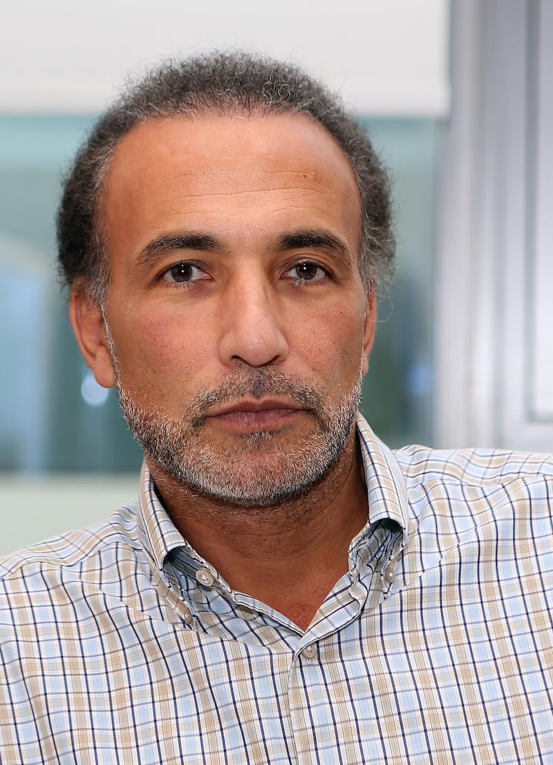 (FILES) This file photo taken on December 14, 2015 shows Swiss Islamologist Tariq Ramadan posing in his office at the Qatar Foundation in Doha. 
A third woman has filed rape complaints against the prominent Islamic scholar Tariq Ramadan, already indicted over similar charges and in custody, judicial sources told AFP on March 7, 2018. / AFP PHOTO / Karim JAAFAR