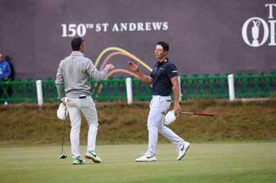 Rory McIlroy of Northern Ireland, left, and Viktor Hovland, of Norway, shake hands on the 18th green. AP.