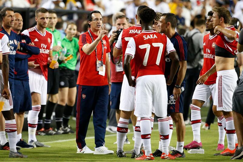 Arsenal head coach Unai Emery talks with players on the sidelines prior to penalty shoot-out. Arsenal would lose 3-2 after the match had finished tied at 2-2 in normal time. Reuters