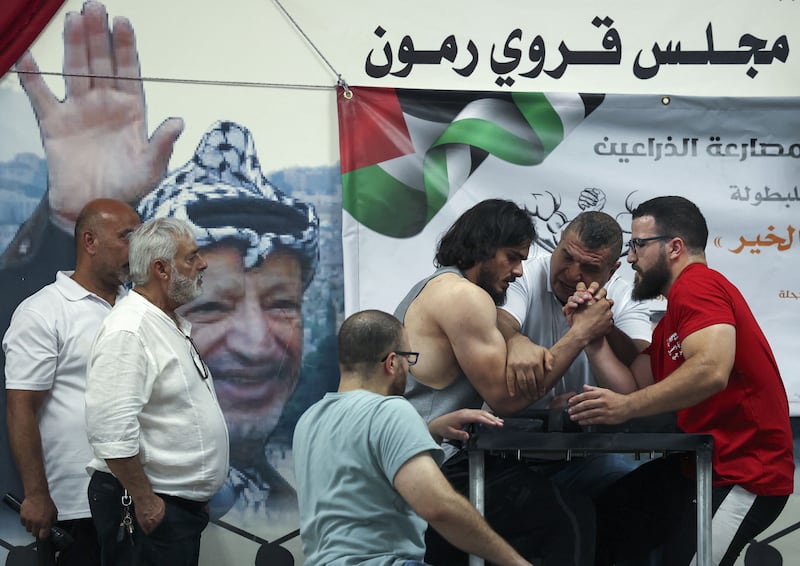 Palestinians take part in a two-day arm-wrestling championship in Rammun village, east of Ramallah, in the West Bank. 