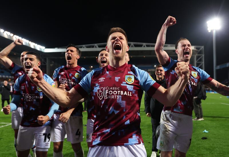 Johann Gudmundsson of Burnley celebrates with teammates after a 1-0 victory over Blackburn Rovers sealed the Championship trophy and with it promotion to the Premier League. Getty Images