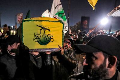 A militia member's coffin is shrouded in the flag of Harakat Al Nujaba. AFP