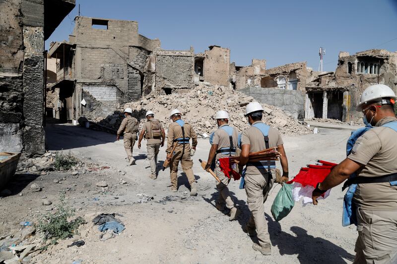 Members of a demining squad take part in an operation to clear mines planted by ISIS militants in the Old City of Mosul, Iraq. All photos: Reuters