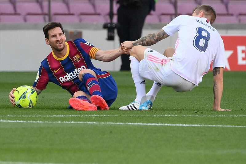 Real's Toni Kroos picks up Lionel Messi after a foul. AFP