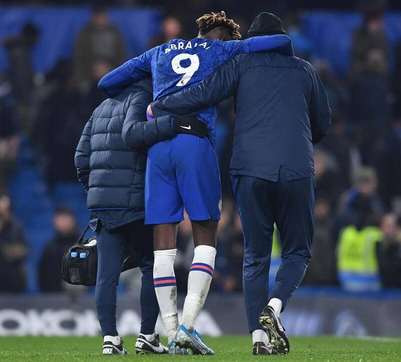 Tammy Abraham is helped off of the pitch at the end of the game against Arsenal at Stamford Bridge. AFP