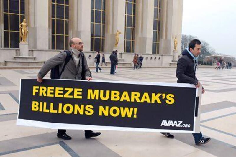 It is estimated that Hosni Mubarak allegedly stole up to US$70 billion during his 30 years in office. Above, people hold a banner urging a freeze to the assets of the former Egypt president. Eric Piermont / AFP