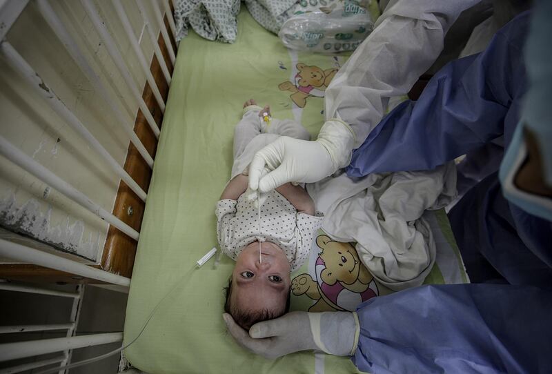 A Palestinian medical takes swab samples for COVID-19 testing from a baby inside Kamal Edwan hospital in Beit Lahiya town, northern Gaza Strip.  EPA