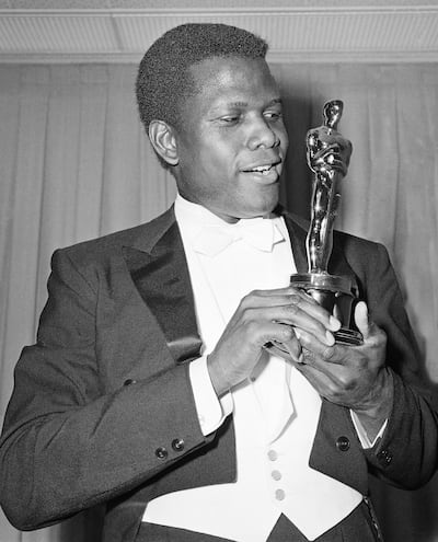 Sidney Poitier poses with his Oscar for Best Actor for 'Lilies of the Field' at the 36th Annual Academy Awards in Santa Monica, California, in 1964. AP 