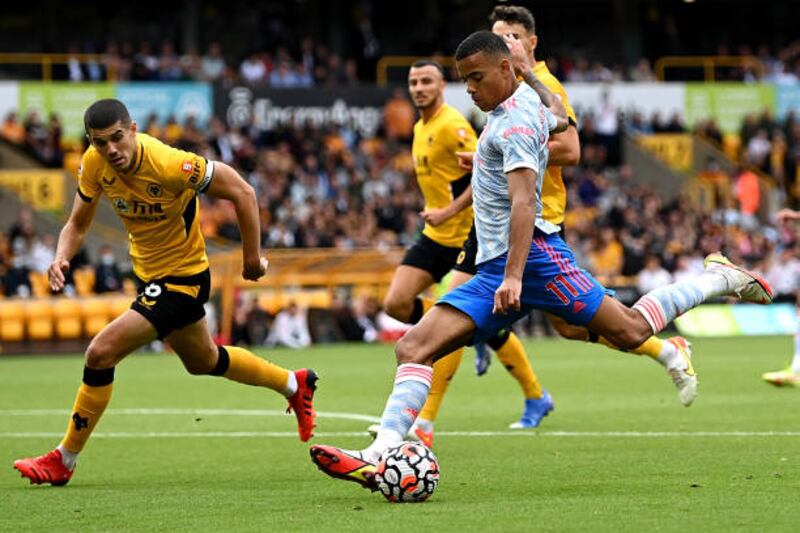 WOLVERHAMPTON, ENGLAND - AUGUST 29: Mason Greenwood of Manchester United battles for possession with Conor Coady of Wolverhampton Wanderers  during the Premier League match between Wolverhampton Wanderers  and  Manchester United at Molineux on August 29, 2021 in Wolverhampton, England. (Photo by Shaun Botterill / Getty Images)