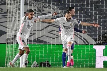 Real Madrid forward Karim Benzema (R) celebrates after scoring against Chelsea. AFP