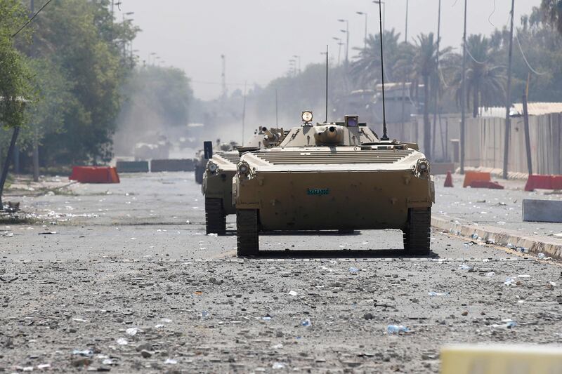 Iraqi armoured security vehicles clash with Saraya Al Salam (Peace Brigade), the military wing affiliated with Mr Al Sadr, as fighting between rival Iraqi forces resumed in Baghdad.  AFP
