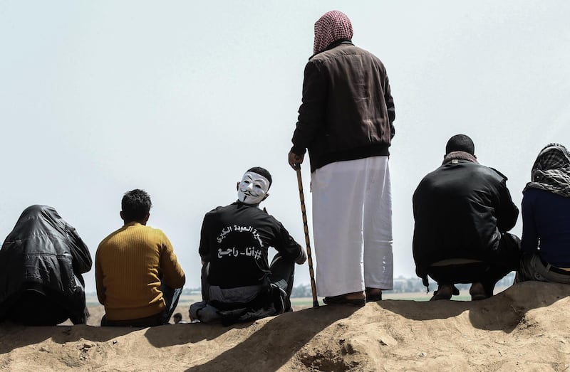 Palestinian men wait for the start of protests near Khan Yunis. AFP