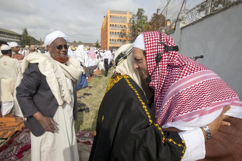 Kenyan Muslims embrace each in Nairobi. Sayyid Abdul Azim / AP Photo
