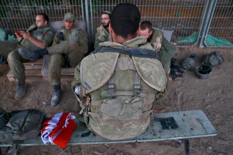 Israeli soldiers rest at an army post near the Israeli-Gaza border, south of Sderot, on Tuesday. AFP