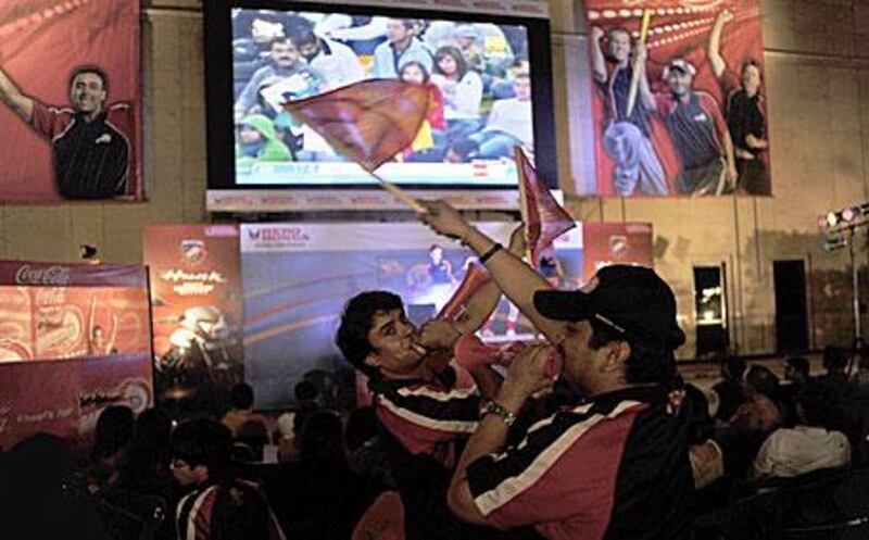 The drawing power of the IPL: fans cheer on their team on television at a New Delhi mall.