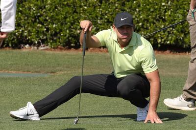 AUGUSTA, GEORGIA - APRIL 06: Brooks Koepka of the United States crouches as he lines up a putt on the practice green during a practice round prior to the Masters at Augusta National Golf Club on April 06, 2021 in Augusta, Georgia.   Kevin C. Cox/Getty Images/AFP
== FOR NEWSPAPERS, INTERNET, TELCOS & TELEVISION USE ONLY ==

