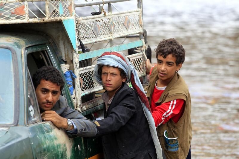 Yemenis try to get a broken down car out of a flooded road following heavy rains in Sana, Yemen. Heavy rains hit the Yemeni capital Sana'a and most parts of the low rainfall Arab country.  EPA