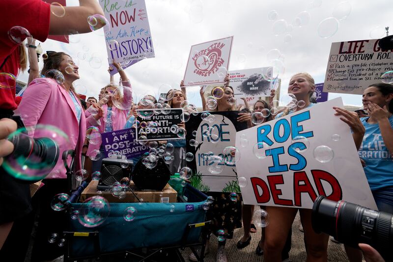 Pro-life demonstrators celebrate outside the Supreme Court in Washington. AP