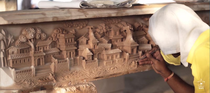 A screenshot showing craftsmen in India working on the columns and pillars of the Hindu temple in Abu Dhabi. Courtesy: BAPS Hindu Mandir