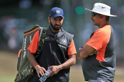 India's Cheteshwar Pujara, left and head coach Ravi Shastri talk during a nets session at Edgbaston a day ahead of the 1st test cricket match between England and India, at Edgbaston, in Birmingham, England, Tuesday July 31, 2018. (Mike Egerton/PA via AP)
