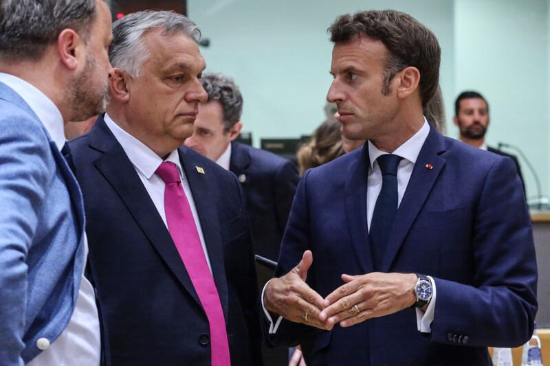 Hungary's Prime Minister Viktor Orban (in pink tie) and French President Emmanuel Macron in discussion. Bloomberg