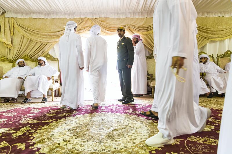 Al Ain, United Arab Emirates, August 13, 2017:    Men gather to pay their respects to the family of Captain Ahmed Khalifa Al Baloushi, 27, a UAE soldier who died in a helicopter crash while serving in Yemen,at a majalis outside the Al Towayya mosque in the Al Towayya area of Al Ain on August 13, 2017. Christopher Pike / The National

Reporter: Nawal Al Ramahi
Section: News