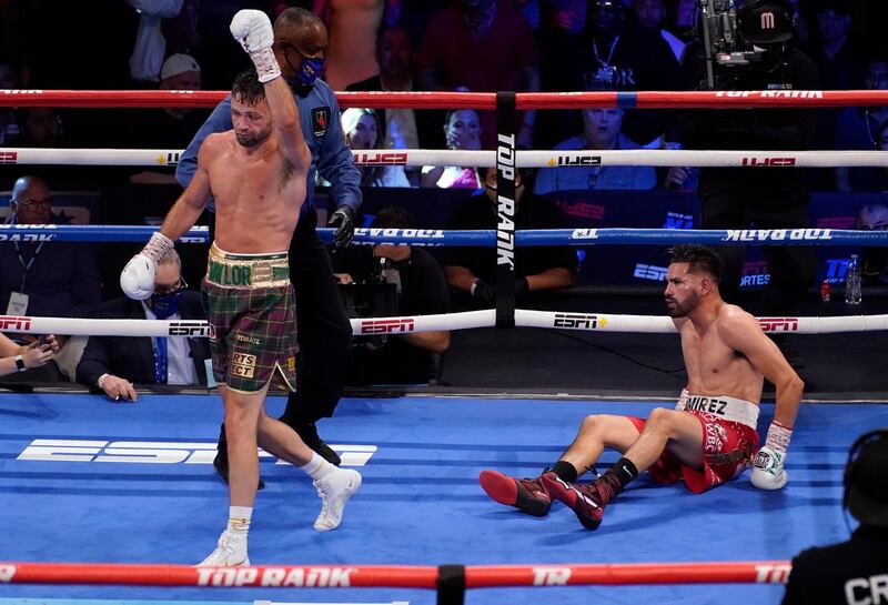 Josh Taylor walks away after knocking down Jose Ramirez during their light-welterweight title fight in Las Vegas on Saturday, May 22. Taylor won a unanimous points decision to become Britain's first undisputed four-belt world champion. PA