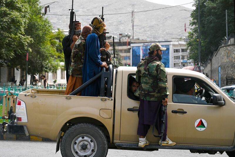 Taliban fighters in an Afghan government forces pickup patrol the streets of Kabul. AFP