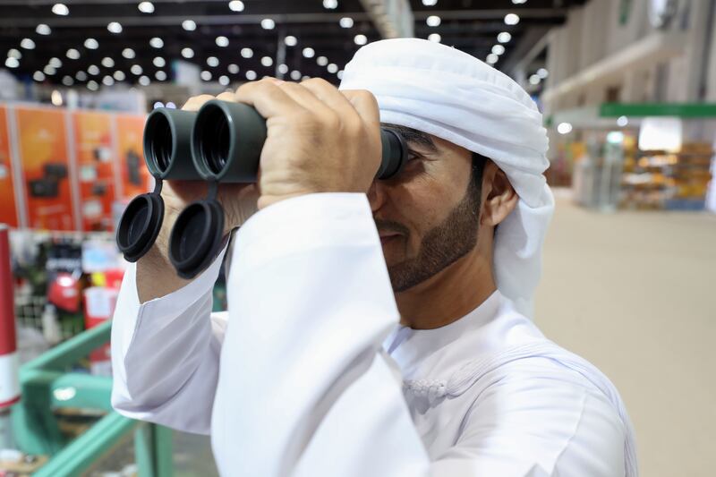 Fayez Al Habsi tests a pair of binoculars. Chris Whiteoak / The National