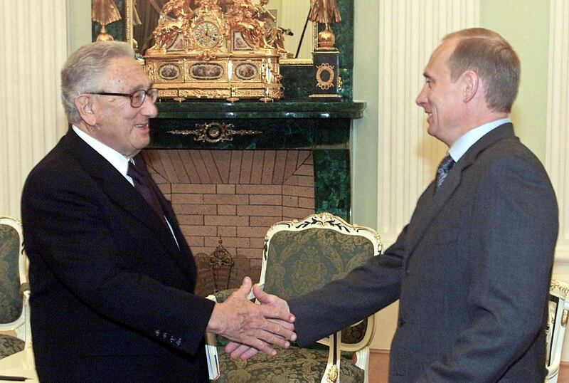 Russian President Vladimir Putin meets Mr Kissinger in the Kremlin, in 2001. AFP