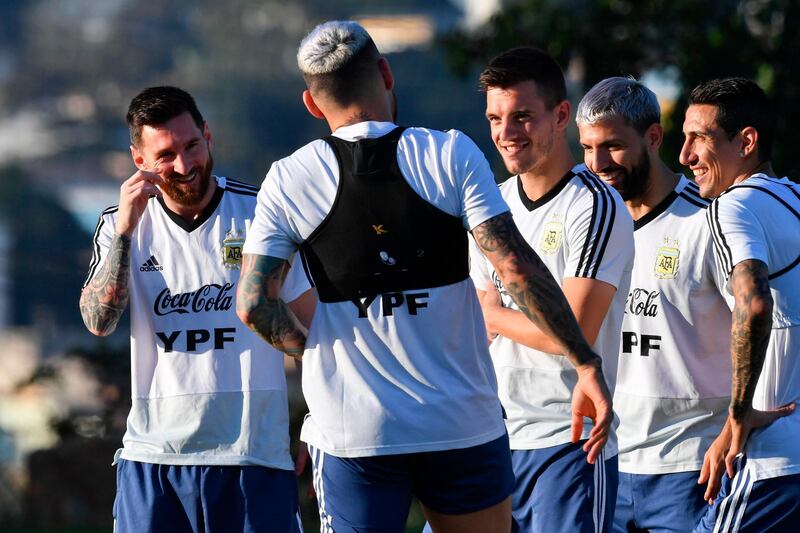 Lionel Messi, left, shares a joke with Argentina teammates Nicolas Otamendi, Rodrigo De Paul, Sergio Aguero, and Angel Di Maria. AFP