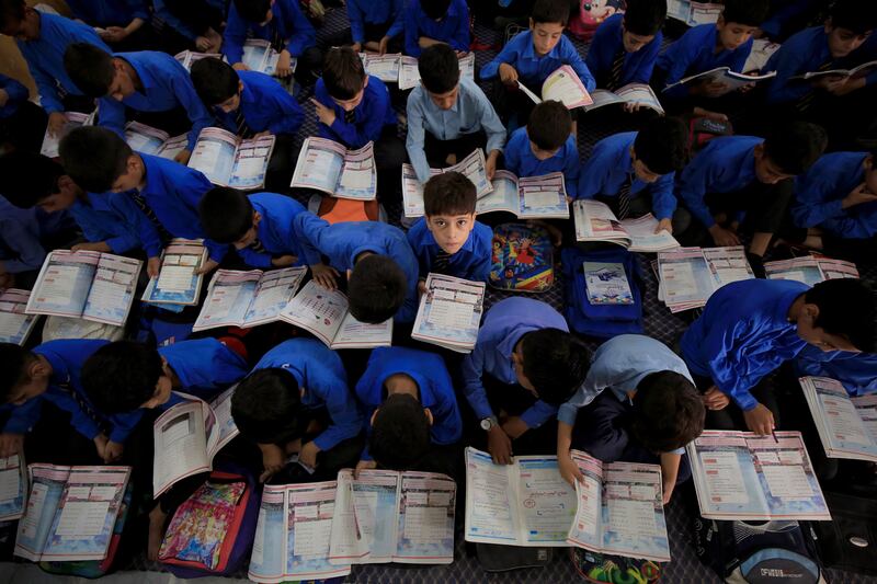 Pakistani boys attend a class on International Literacy Day in Peshawar, Pakistan. EPA