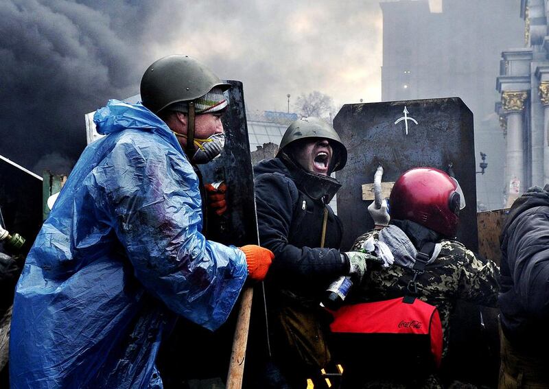 Protesters advance to new positions in Kiev. Top officials were evacuated on Thursday from Ukraine’s main government building close to clashes in the heart of Kiev. “This morning, all cabinet employees were evacuated from the building. These were official orders,” a spokeswoman for the Ukrainian government said. Louisa Gouliamaki / AFP