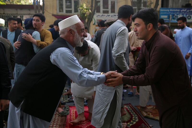 Afghan Muslims greet each other after offering Eid al-Adha prayers in Kabul, Afghanistan, Friday, July 31, 2020. During the Eid al-Adha, or Feast of Sacrifice, Muslims slaughter sheep or cattle and distribute portions of the meat to the poor. (AP Photo/Rahmat Gul)