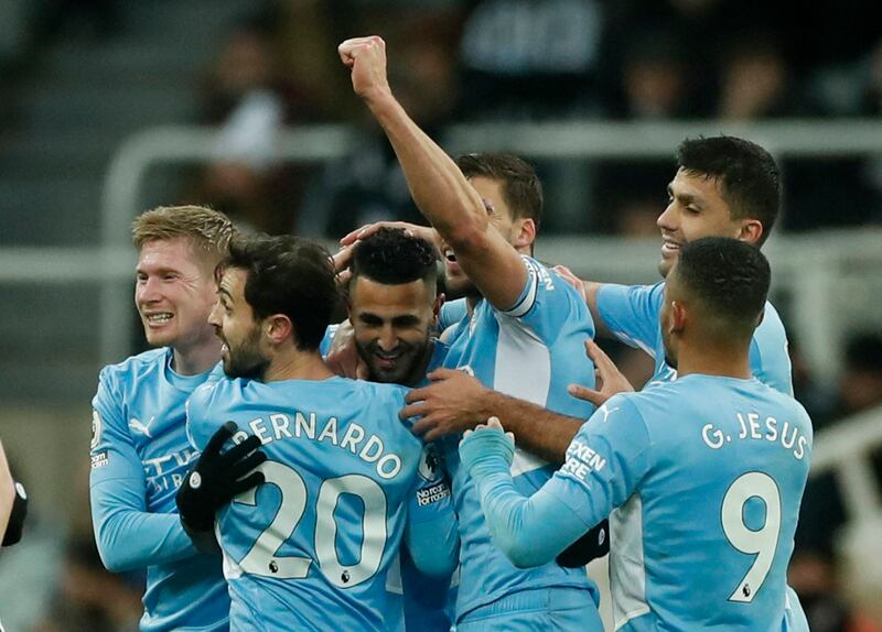 Riyad Mahrez is mobbed after scoring City's third goal. Reuters